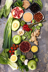 Healthy food clean eating selection. fruit, vegetable, seeds, superfood, cereals, leaf vegetable on rustic background