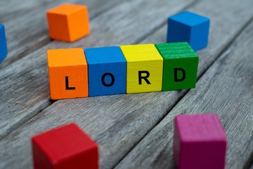 colored wooden cubes with letters. the word lord is displayed, abstract illustration