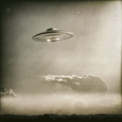 Unidentified flying object. Old style photo with noise of high ISO film.