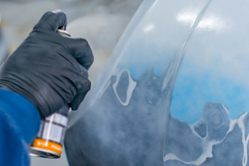 paint spray can in the hand of a worker