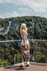  Skypark in Sochi, extreme summer jumping in the mountains. Tourist girl in skypark