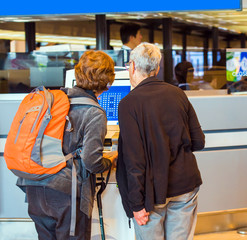 Two women at the front desk at the airport, Tokyo, Japan. Back view. With selective focus.
