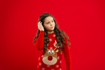 Happy winter holidays. Small upset girl. New year party. Santa claus kid. Little girl child in santa red hat. Present for Xmas. Childhood. Christmas shopping. red background