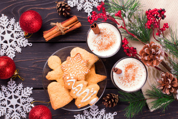 Christmas eggnog in glass mug and cinnamon.