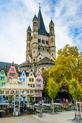 Naklejka premium COLOGNE - NOVEMBER 07, 2018 : Colorful houses in front of St. Martin's church on november 07, 2018 in Cologne