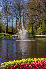 Fototapeta premium Lisse, Netherlands - April 18, 2016: People and lake in the park of flowers Keukenhof