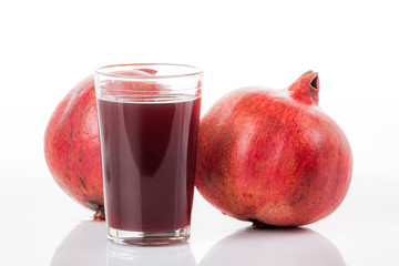 Pomegranate juice with pomegranate isolated on a white background