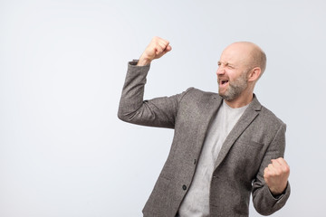 Portrait of a satisfied mature man celebrating success