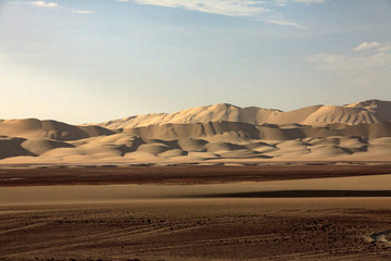Fototapeta na wymiar The desert in Paracas in Peru. Sun sea and sand