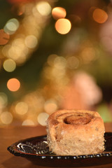 a cinnamon roll with Chrismas bokeh in the background