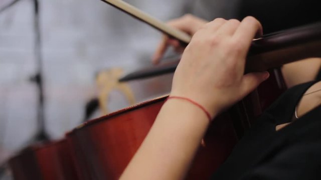 Musician playing violin outdoors, hand close up. Wedding music concept. Violin concert. 