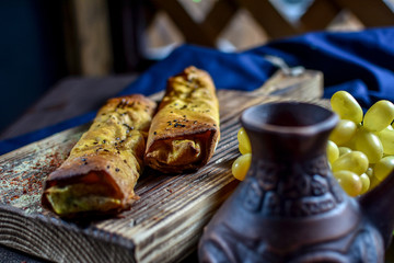 Traditional Georgian khachapuri on the table with grapes. Homemade baking recipe.