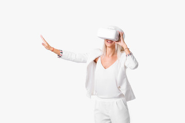 Blond woman in white suite with virtual reality goggles. Studio shot on white background