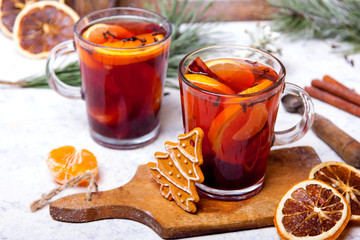 Christmas drink, mulled wine with orange, cinnamon and cloves on white background
