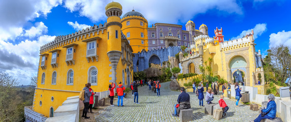 Tourists in front of the main entrace in Pena Palace visiting the most famous historic landmark...