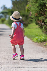 Fototapeta premium little girl runing in the summer Park
