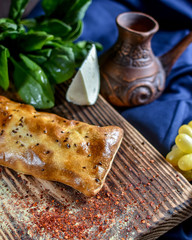 Traditional Georgian khachapuri on the table with grapes. Homemade baking recipe.