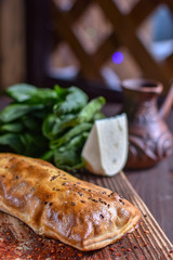 Traditional Georgian khachapuri on the table with grapes. Homemade baking recipe.