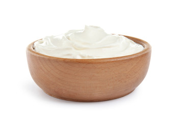 Wooden bowl with fresh sour cream isolated on white