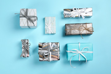 Flat lay composition with beautiful gift boxes on color background