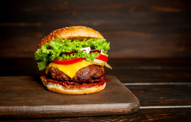 mouth-watering delicious homemade burger used to chop beef on the wooden table