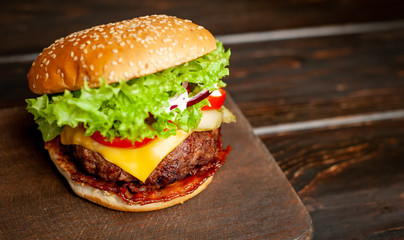 mouth-watering delicious homemade burger used to chop beef on the wooden table
