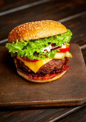 mouth-watering delicious homemade burger used to chop beef on the wooden table