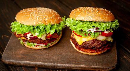 two delicious homemade burger for slicing beef on a wooden table