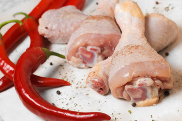 raw chicken with red peppers and spices 