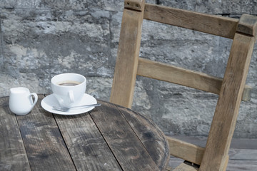 One cup of coffee on wooden table as symbol of loneliness and depression. Moody still life.