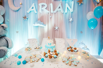 Delicious wedding reception candy bar dessert table full with cakes, sweets, macaroons, eclairs and other types of bakery