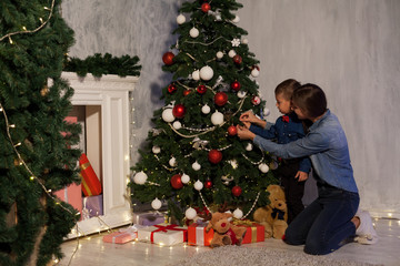 mom with son decorate decoration Christmas tree have new year holiday house