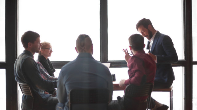 group of creative designers discussing in the Studio. - Powered by Adobe