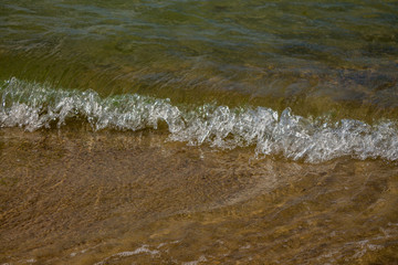 Sea waves on the sandy shore