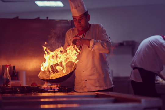 Chef doing flambe on food