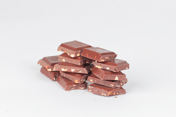 pieces of dark chocolate with nuts isolated on white.photo with 