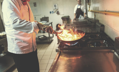 Chef doing flambe on food