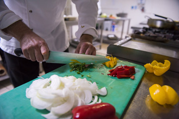 Chef hands cutting fresh and delicious vegetables