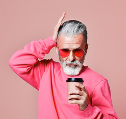 Beautiful senior man bearded in Christmas sweater. Santa Claus wishes Merry Christmas