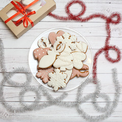 Christmas gingerbread cookies on light wooden background