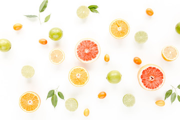 Fototapeta na wymiar Creative background made of summer tropical fruits: grapefruit, orange, lemon, lime and leaves ficus. Food concept. flat lay, top view