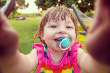 little girl spending time at backyard