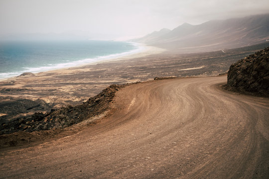 Alternative holiday scenic beahc with nobody there and desert with mountains around the coast - wild scenic place to live amazing adventure - cofete in fuerteventura