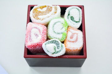 Delicious rolls of Lokum with fruit marmalade in japanese style in black box