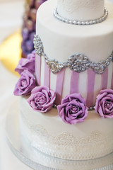 Candy bar table set. Cookies, eclairs, macaroons, fruits, cream and layered cakes. Pastel violet colours.