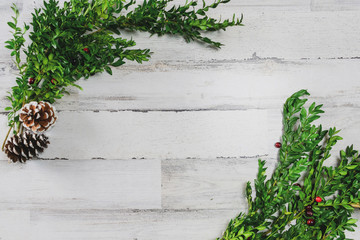 White shiplap background with boxwood greens