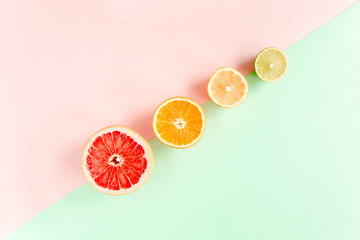 Creative pattern made of summer tropical fruits: grapefruit, orange, lemon, lime on colorful background. Food concept. flat lay, top view