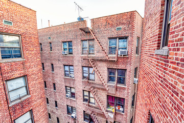 Brick apartment condo building roof exterior architecture in Fordham Heights center, Bronx, NYC,...