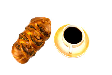 isolated on white background cups and saucers, black coffee and bread braided with poppy seeds.