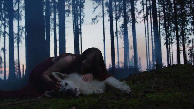 Young woman caressing a dog